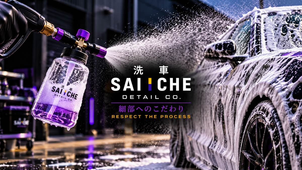 SAI CHE foam cannon with red accents spraying thick white car wash foam onto a black sports car, featuring the SAI CHE Detail Co. logo.